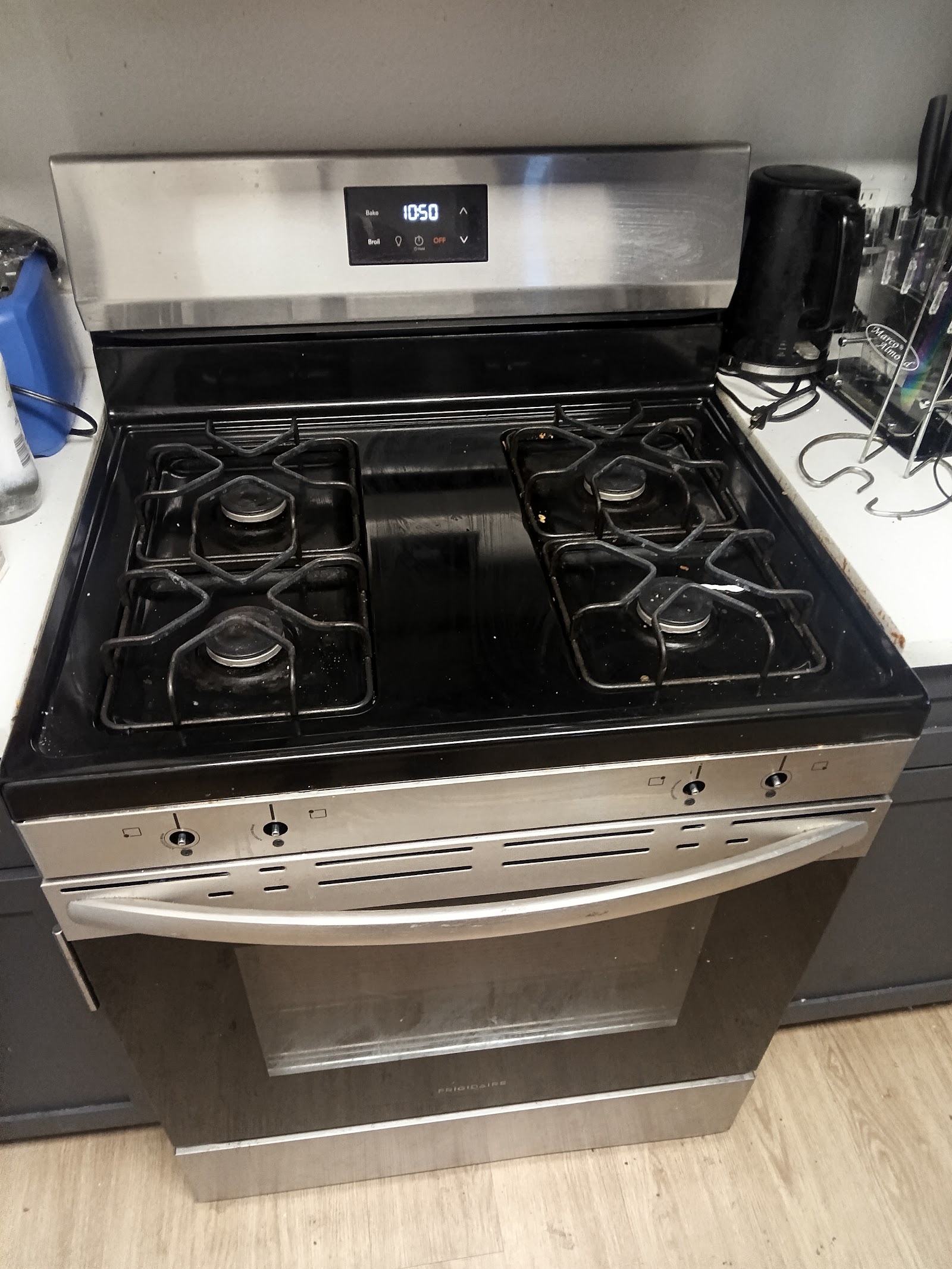Stainless steel Frigidaire gas range with digital display showing 10:50