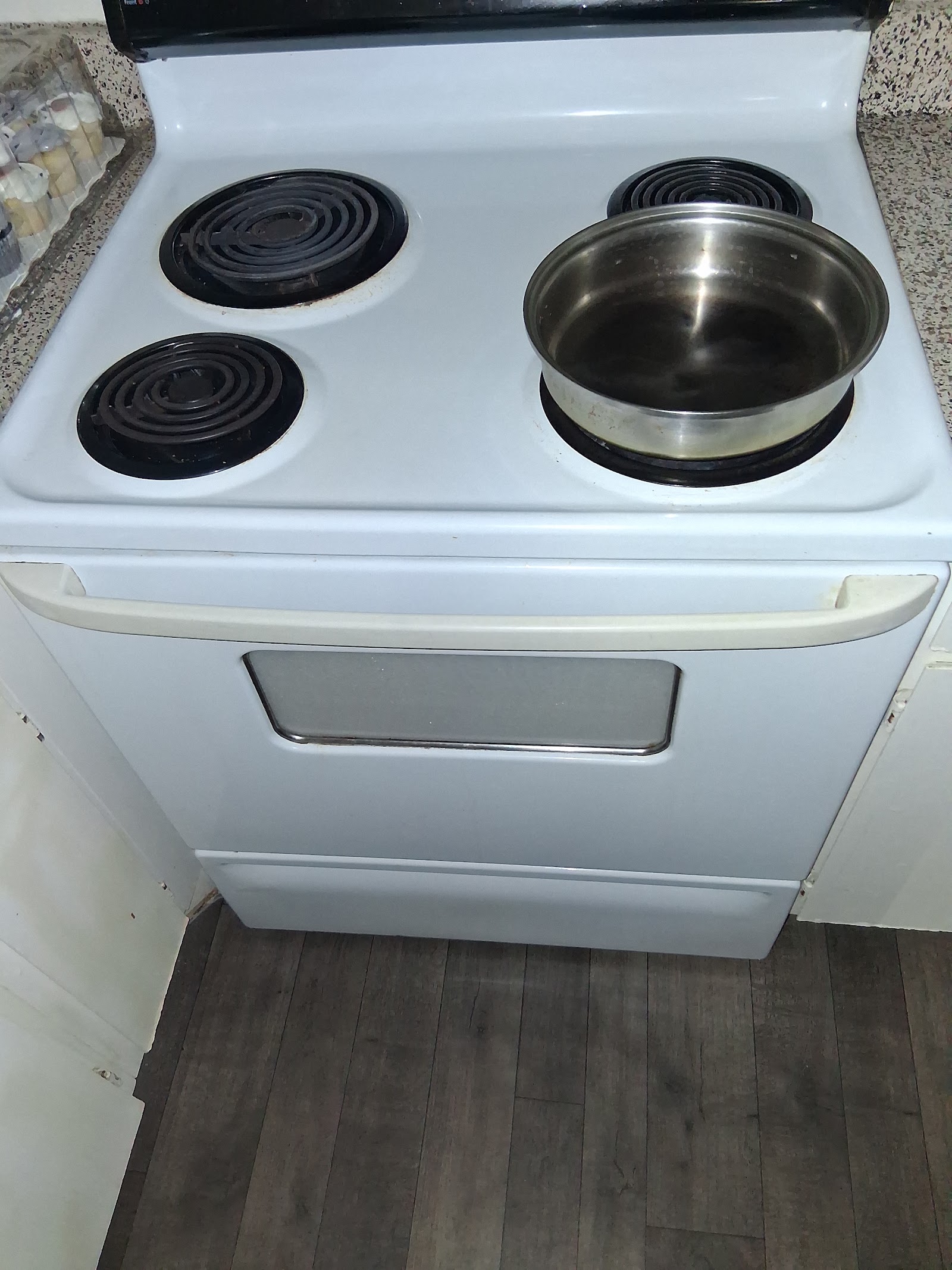 White electric coil range with pot on burner